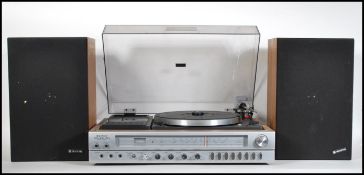A retro 20th Century Sanyo G2002 stereo music system, consisting of record deck, tape deck, radio