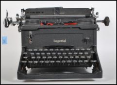 An early 20th century vintage industrial manual typewriter by Imperial, having an A3 roller and