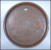 A very heavy and unusual believed 19th century copper charger decorated with central leaf and