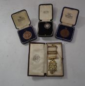 A group of 20th Century medals one being Masonic silver medal on a white ribbon, another silver with