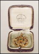 A late 19th Century / early 20th Century stamped 9ct gold open work pendant of round form set with