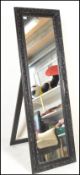 A large freestanding bedroom antique style Versailles type easel mirror. Full size with carved