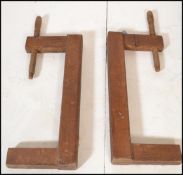 A pair of 19th century German wooden clamps with large thread handles together with a pair of 20th