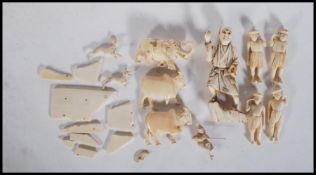 A group of late 19th Century carved ivory figurines to include Indian figures and animals