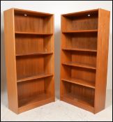 A pair of tall retro teak wood open window bookcases fitted with a series of adjustable shelves