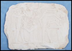 A carved limestone Egyptian wall relief fragment after a wall relief at the necropolis at Saqqara