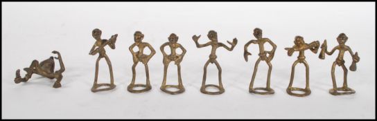 A collection of cast bronze Akan Ashanti gold weights in the form of men, some modelled playing