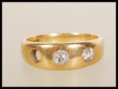 A stamped 18ct gold gypsy ring set with two round cut diamonds (the third is missing). Weight 6.
