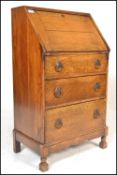 A 1920's solid oak ladies writing bureau. Of thin upright form being raised on stub cabriole legs