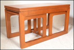 A retro 20th Century Danish inspired teak wood coffee table \ nest, flip over extending table top