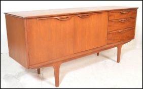 A mid 20th Century retro teak wood sideboard / credenza, having twin cupboard doors to left