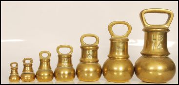 A set of seven 19th / 20th Century graduating brass bell weights, the largest weighing 14LB's and