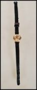 A marked 18k gold ladies wrist watch by Tudor having gilt baton numerals with faceted hands, set