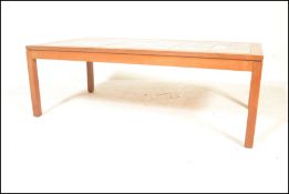 A  mid 20th century large Danish inspired teak wood and tile top long john coffee table. Raised on