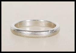 A hallmarked platinum band ring having worn decoration to band. Hallmarked Birmingham, weight 4.