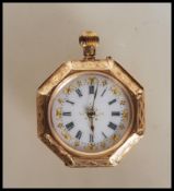 A stamped 14ct gold pocket fob watch of octagonal form having engraved floral decoration with
