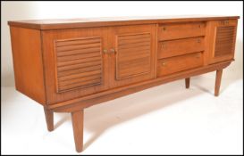 A retro 20th Century Danish inspired teak wood sideboard credenza, the sideboard having a bank of