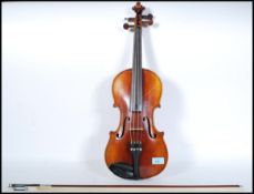 An early 20th Century Continental violin, the two piece back of faint medium curl with similar