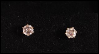 A pair of 18ct white gold stud earrings prong set with two brilliant cut diamonds. Weight 0.9g.