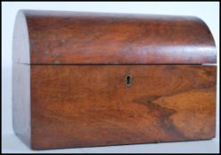 A late 19th Century mahogany dome top tea caddy of simple form having brass escutcheon, locking