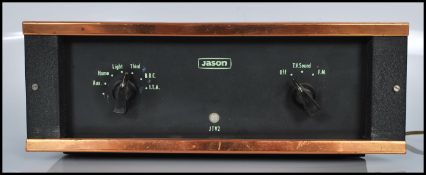 A vintage Jason JTV2 sound amplifier unit having copper mounts.