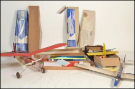 Two vintage remote controlled glider planes to include a larger red and white plane with a canvas