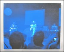 A photographic canvas depicting Portishead on stage featuring Beth Gibbons at the microphone.