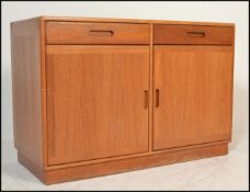 A 20th Century Danish teak wood sideboard / credenza having a configuration of two drawers over