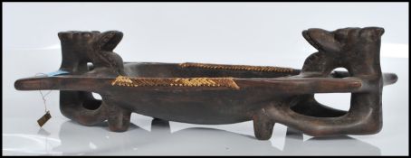 A 20th Century carved African hardwood tribal tray of rectangular form having carved horses to the