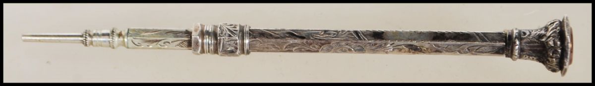 A 19th Century Victorian silver propelling pencil of hexagonal form engraved with floral detailing