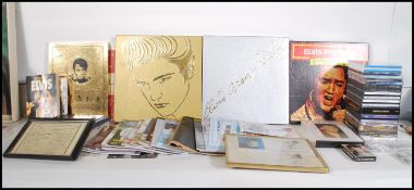 A collection of Elvis Presley related music memorabilia to include a vinyl record box set, tape