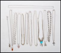 A group of silver necklaces to include a multi chain necklace set with a turquoise stone cabochon, a