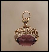 A hallmarked 375 9ct gold mounted swivel fob, the mount having pierced fretwork with rope twist