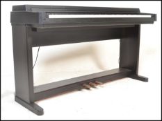 Musical Instruments. A Yamaha Clavinova CLP- 440 digital piano having an ebonised finish to the