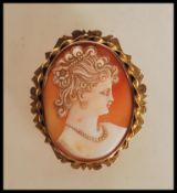 An early 20th century 9ct gold mounted cameo pendant / brooch. The brooch having a carved shell