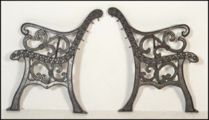 A pair of 20th Century cast iron scroll work garden bench ends together with a pair of metal