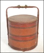 A vintage 20th Century Chinese bamboo woven lacquered and brass bound wedding food storage pot,