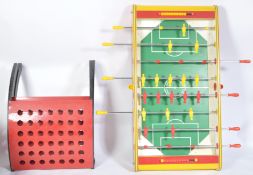 A contemporary Fussball - table football game. In red colourway with players on swing and pull arms