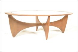 A 1950's mid century teak wood Danish influence coffee table of sputnik / Astro form. Inset glass