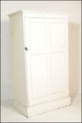 An early 20th century painted pine housekeepers cupboard / wardrobe. Raised on a plinth base with