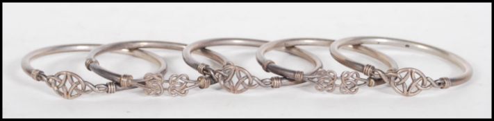 A group of five silver hallmarked bangles, each bangle having Celtic knot decoration. Hallmarks