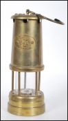 A 20th Century brass miners safety lamp  with hanging hook to the top and applied plaque with a