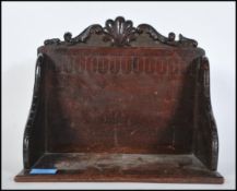A late 19th Century Victorian oak table book trough having carved decoration throughout with shell