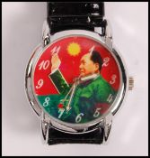A gentleman's wrist watch, the face printed with an image of Chairman Mao with an articulated waving