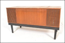 A vintage retro teak cased His Masters Voice radiogram opening to reveal a WYE electronic turntable,