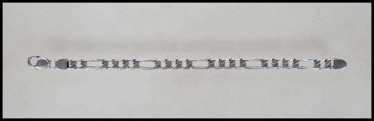 A silver hallmarked Italian 925 Figaro bracelet set with a lobster claw clasp, measures 8