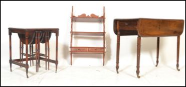 A 19th century mahogany pembroke dining table being raised on turned legs with end drawer and drop