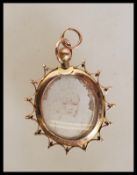 An early 20th Century Edwardian hallmarked 9ct gold mourning / photo panel pendant of oval form