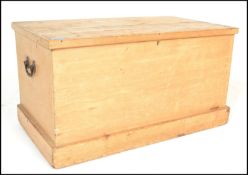 A 19th Century Victorian scrubbed pine blanket box raised on a plinth base with cast metal swing