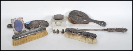A collection of silver hallmarked items to include a silver topped glass desk top inkwell,